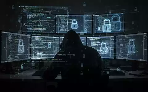 A shadowy figure at computers, representing cybercrime and data theft. - Foto: über boerse-global.de