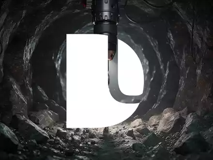 Bohrmaschine in einem dunklen, felsigen Tunnel, symbolisiert Bergbau und Exploration. - Foto: über boerse-global.de