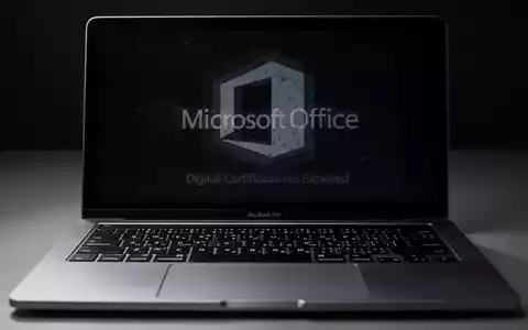A close-up of a MacBook Pro keyboard with a faded Microsoft Office logo on the screen, symbolizing software obsolescence. - Foto: über boerse-global.de