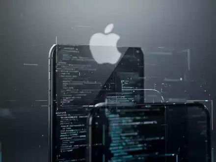 An iPhone with a screen showing abstract code, hinting at hidden features. A blurred Apple logo is in the background. - Foto: über boerse-global.de