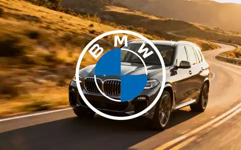 Ein glänzender, moderner BMW X5 fährt auf einer kurvigen Straße, mit einer verschwommenen Landschaft im Hintergrund. - Foto: über boerse-global.de