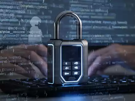 Ein digitales Vorhängeschloss, das über abstrakten Codezeilen und einer Hand schwebt, die eine Tastatur berührt, symbolisiert Cybersicherheit. - Foto: über boerse-global.de