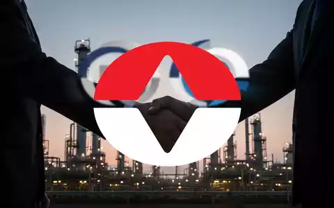 Zwei symbolische Unternehmenslogos verschmelzen, während sich zwei Führungskräfte vor einem Chemiewerk die Hand geben, das eine Fusion darstellt. - Foto: über boerse-global.de