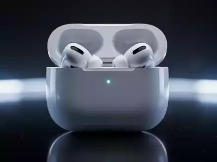 Apple AirPods Pro 3 in their open charging case, glowing with a soft blue light, on a reflective dark surface. - Foto: über boerse-global.de