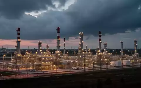 Ein großes, modernes Energie-Hub-Anlage in Ravenna bei Sonnenuntergang, mit hellen Lichtern und komplexen Industriestrukturen. - Foto: über boerse-global.de