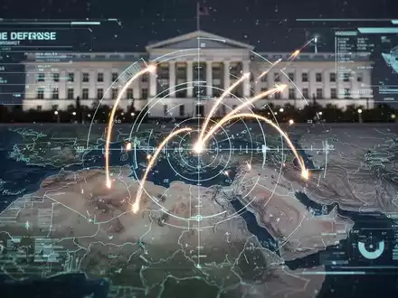 A holographic display showing missile trajectories over a map of the Middle East, with a faint Pentagon building in the background. - Foto: über boerse-global.de