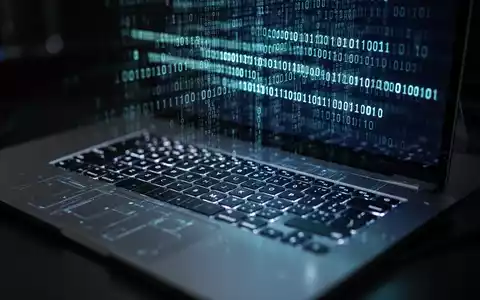 Close-up of a laptop keyboard with binary code reflected on the screen, representing enterprise technology and security challenges. - Foto: über boerse-global.de