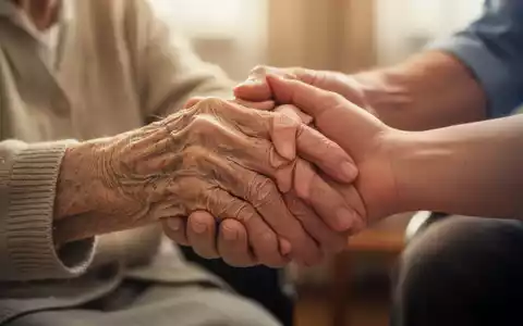 Eine ältere Hand wird sanft von einer jüngeren Hand gehalten, symbolisiert Fürsorge und Unterstützung für Demenzkranke. - Foto: über boerse-global.de