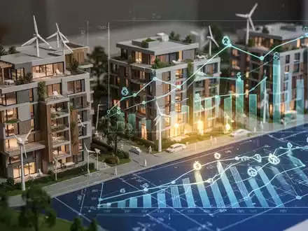 Ein detailliertes Architekturmodell moderner, nachhaltiger Wohngebäude mit einer Blaupausenüberlagerung, die Finanzgrafiken und Steuersymbole zeigt. - Foto: über boerse-global.de