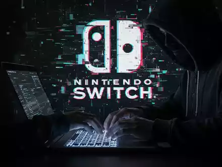 A shadowy figure in a hoodie types on a laptop, with a pixelated Nintendo Switch logo in the background, symbolizing a cyberattack. - Foto: über boerse-global.de