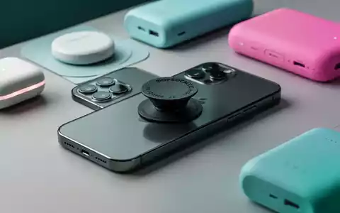 A modern smartphone with a low-profile PopSockets grip, surrounded by colorful wireless chargers and power banks on a clean surface. - Foto: über boerse-global.de