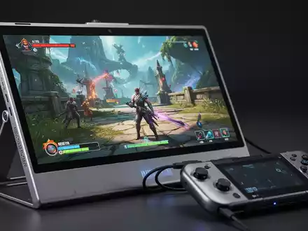 A portable monitor displaying a video game, connected to a handheld gaming PC like a Steam Deck, on a desk. - Foto: über boerse-global.de