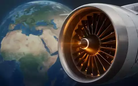 Eine Nahaufnahme eines modernen Flugzeugturbinenmotors, teilweise golden beleuchtet, vor einem unscharfen Hintergrund einer Weltkarte. - Foto: über boerse-global.de