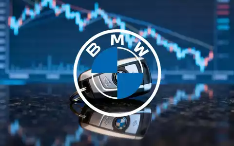 Ein einzelner BMW-Autoschlüssel liegt auf einer dunklen Oberfläche, im Hintergrund eine unscharfe, fallende Börsenkurve. - Foto: über boerse-global.de