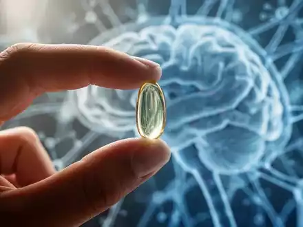 Eine Hand hält eine Fischölkapsel vor einem verschwommenen Hintergrund aus abstrakten neuronalen Mustern, die kognitive Gesundheit symbolisieren. - Foto: über boerse-global.de
