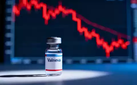 Eine Valneva-Impfflasche vor einem unscharfen, stark fallenden Aktienchart mit roten Linien. - Foto: über boerse-global.de