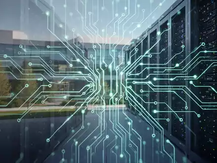 A glowing, intricate digital neural network pattern overlaid on a blurred image of modern server racks, symbolizing AI and restructuring. - Foto: über boerse-global.de