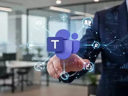 Hand interacting with a holographic interface showing Microsoft Teams logo and network icons in a modern office setting. - Foto: über boerse-global.de