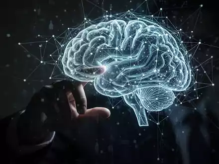 A shadowy hand touches a glowing digital network overlaying a human brain, symbolizing AI, data, and privacy concerns. - Foto: über boerse-global.de