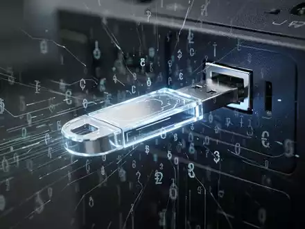 Ein leuchtender, futuristischer USB-Stick steckt in einem dunklen Computeranschluss, umgeben von abstrakten digitalen Linien und kryptografischen Symbolen, die Datendiebstahl und Cyber-Bedrohung andeuten. - Foto: über boerse-global.de