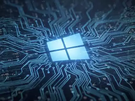 A glowing blue circuit board with digital data streams and a faint Windows logo, representing device management and updates. - Foto: über boerse-global.de