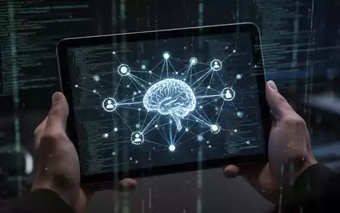 A tablet screen displaying a glowing, intricate neural network or knowledge graph, held by hands in a dark, high-tech setting. - Foto: über boerse-global.de