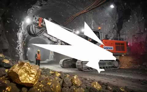 Ein Sandvik-Bohrgerät in einem unterirdischen Bergwerk, mit einem Bergmann und sichtbarem Golderz. - Foto: über boerse-global.de