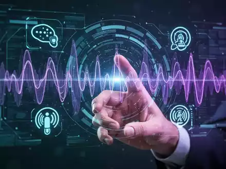 A human hand interacts with a holographic interface showing sound waves and AI symbols, representing bidirectional voice technology. - Foto: über boerse-global.de