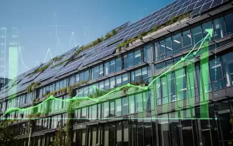 Eine moderne Bürogebäude-Fassade mit Solarpaneelen und grünen Elementen, die Energieeffizienz und Nachhaltigkeit symbolisiert. - Foto: über boerse-global.de