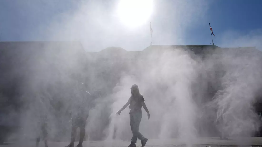 Wassernebel zur Abkühlung: Nicht nur in Hamburg ist jede Hitzepause willkommen. - Bild: Marcus Brandt/dpa
