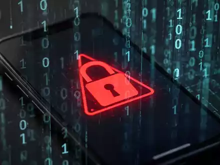 A close-up of a smartphone screen with a digital warning symbol, representing Android malware and cybersecurity threats. - Foto: über boerse-global.de