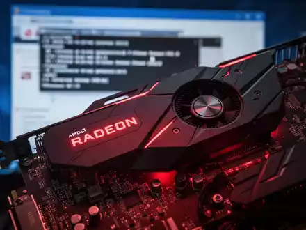 Close-up of a high-performance AMD Radeon graphics card with glowing red lights, circuit board details, and a blurred background. - Foto: über boerse-global.de