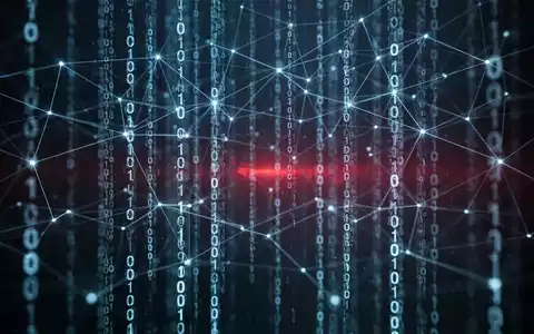 Ein abstraktes Bild, das ein blau leuchtendes digitales Netzwerk und herabfließenden Binärcode vor einem dunklen Hintergrund zeigt, mit einem roten Licht in der Ferne. - Foto: über boerse-global.de