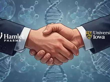 Zwei Hände schütteln sich, die Hamlet Pharma und die University of Iowa symbolisieren, mit wissenschaftlichen Elementen im Hintergrund. - Foto: über boerse-global.de