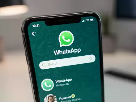 Nahaufnahme eines iPhone-Bildschirms mit WhatsApp und Suchleiste, die neue Kanalsuche symbolisiert. - Foto: über boerse-global.de