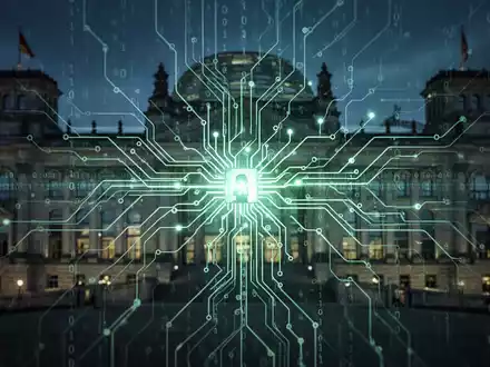 Eine stilisierte, leuchtende neuronale Netzstruktur mit Binärcode, die KI und Cyberbedrohungen darstellt, vor dem unscharfen Umriss des Reichstagsgebäudes. - Foto: über boerse-global.de