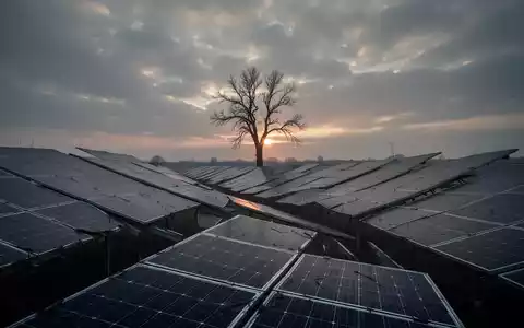 Solarpark mit Reihen von Solarmodulen unter einem bewölkten Himmel, bei Sonnenuntergang, der eine unsichere Zukunft andeutet. - Foto: über boerse-global.de