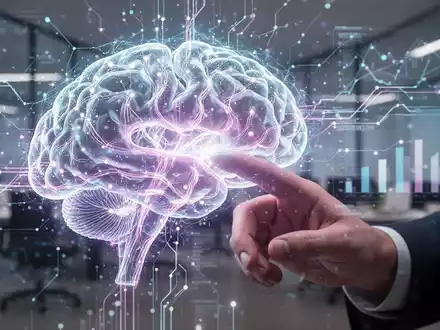 Eine menschliche Hand interagiert mit einer futuristischen, leuchtenden holographischen Oberfläche, die ein digitales Gehirn und Datenströme zeigt. - Foto: über boerse-global.de