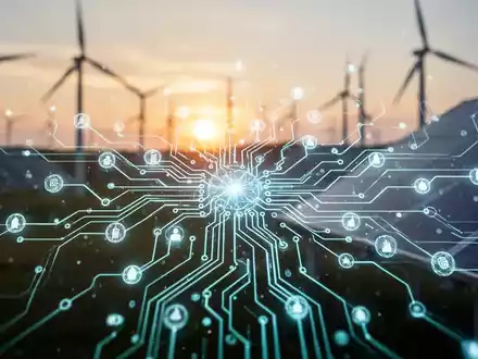 Eine stilisierte, leuchtende Platine vor einem Hintergrund aus Windturbinen und Solarpaneelen bei Sonnenuntergang. - Foto: über boerse-global.de