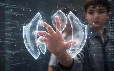 Junge Hand interagiert mit digitalem Interface, schützende Lichtschilde formen sich um die Finger. - Foto: über boerse-global.de