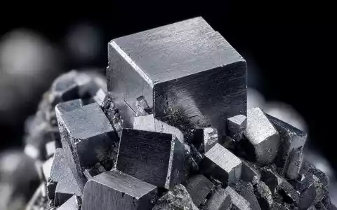 Almonty Industries Inc zeigt Wolfram CA0203987072 in extremer Makroaufnahme glänzender metallischer Kristallflächen - Foto: THN
