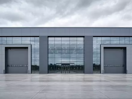BYD Company Ltd (CNE100000296) – kubische Glas-Stahl-Fabrikfassade mit großen Hallentoren in klarer Architekturphotographie - Foto: THN