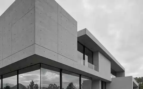 Holcim AG CH0012214059 moderner Sichtbetonbau mit klaren geometrischen Linien und grossflächiger Glasfassade - Foto: THN