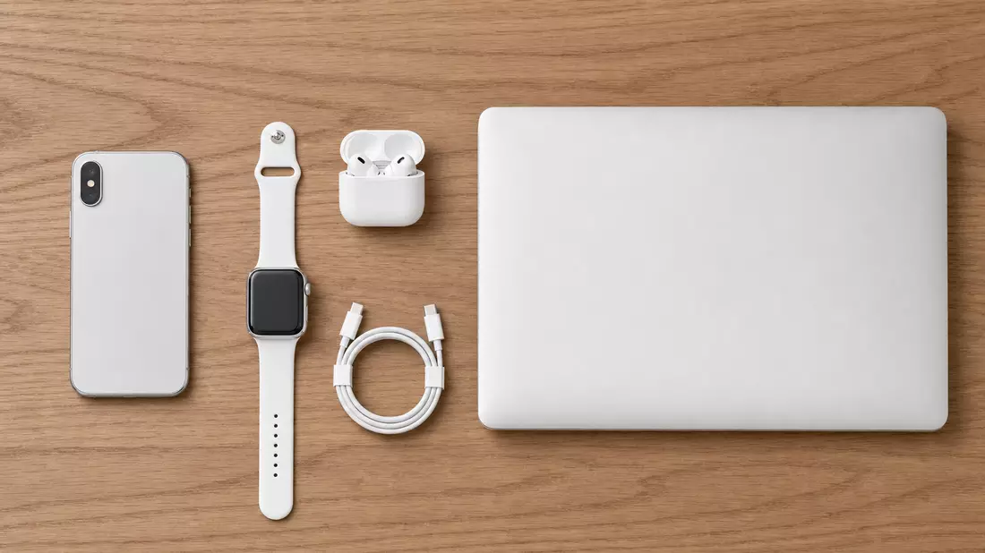 Top-down flat lay product photography on warm walnut wood. Precisely arranged unbranded silver smart