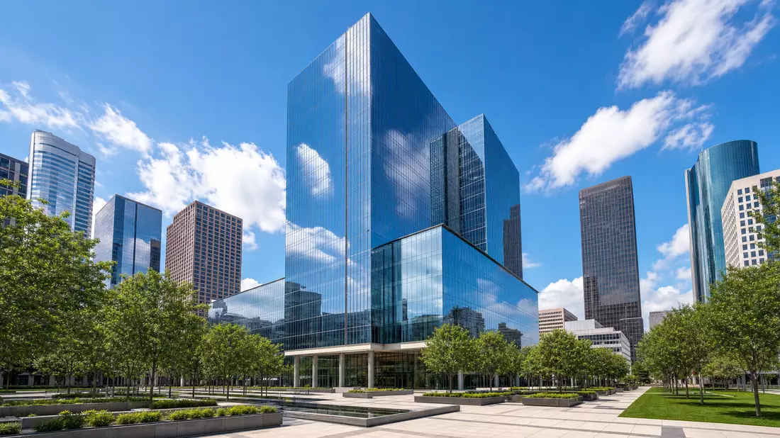 Modern corporate headquarters glass skyscraper in Houston Texas architectural style, gleaming curtain-wall glass tower reflecting blue sky and clouds, clean geometric facade, manicured plaza with low ornamental trees, wide-angle architectural photography,