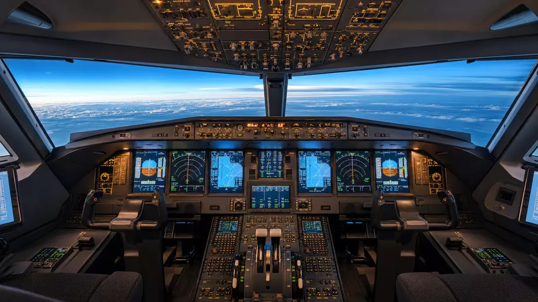 Photorealistic wide-angle view of a modern commercial aircraft glass cockpit interior showing multip