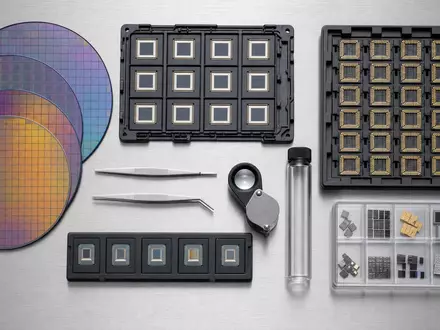 Intel Corporation US4581401001 Flatlay mit Silizium-Wafern, CPU-Trägern, Pinzette und Lupe auf Edelstahl - Foto: THN