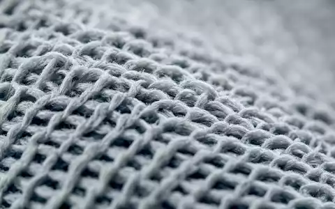 Nike Inc US6541061031 zeigt extreme Makro Nahaufnahme der feinen Strickgewebetextur eines generischen Sportschuhs - Foto: THN