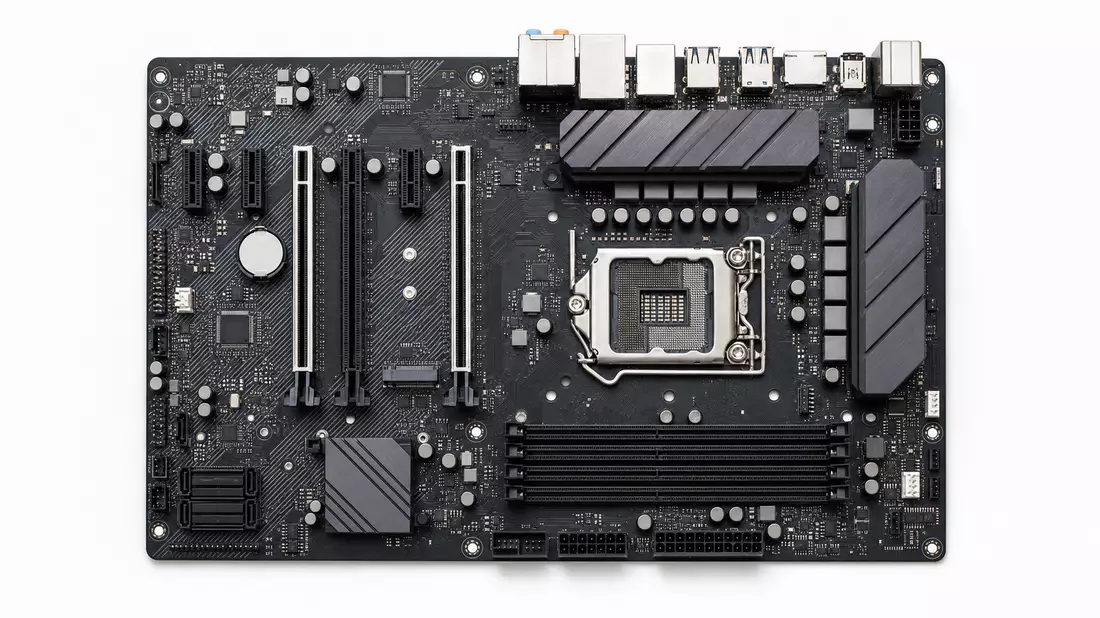 Overhead-Flatlay eines generischen Mainboards mit CPU-Sockel, RAM-Slots und PCIe-Steckplätzen auf weißem Hintergrund, scharfe Studioausleuchtung, kein Markenname