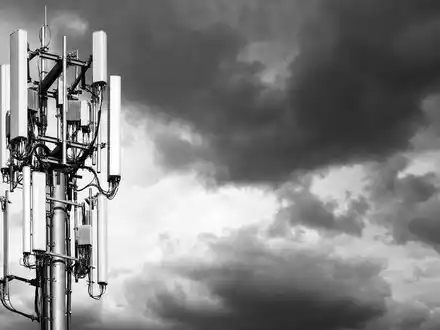 Qualcomm US7475251036 dokumentiert 5G Antennenmast vor dramatischem bewölkten Himmel als Schwarz Weiß Reportage - Foto: THN